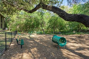 a picnic area with benches and a tree at South Lamar Village, Austin